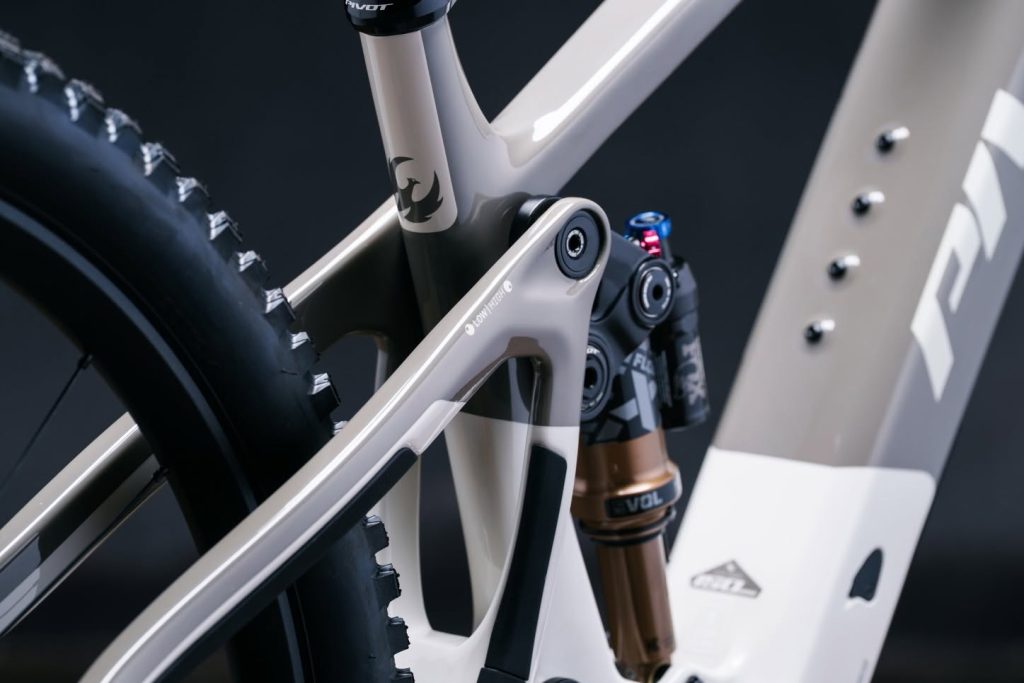 Close-up studio view of a premium Pivot mountain bike frame linkage and Fox rear suspension setup.