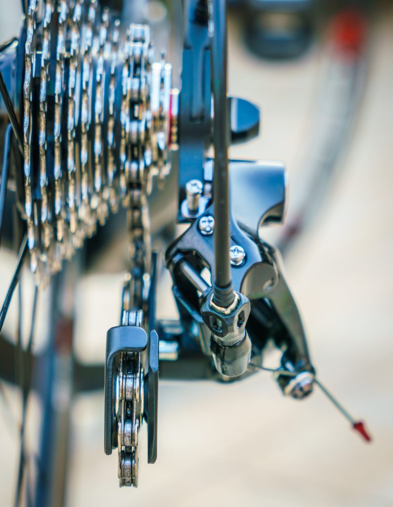 Close-up of a pristine, professionally adjusted multi-speed rear cassette and derailleur, illustrating expert electronic or mechanical gear indexing at Bike Improve.