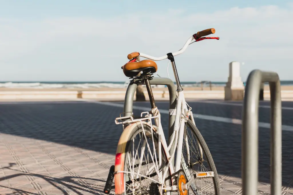 White bicycle parked along a beachfront promenade, representing West Los Angeles bike routes and coastal cycling.