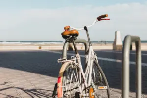 White bicycle parked along a beachfront promenade, representing West Los Angeles bike routes and coastal cycling.